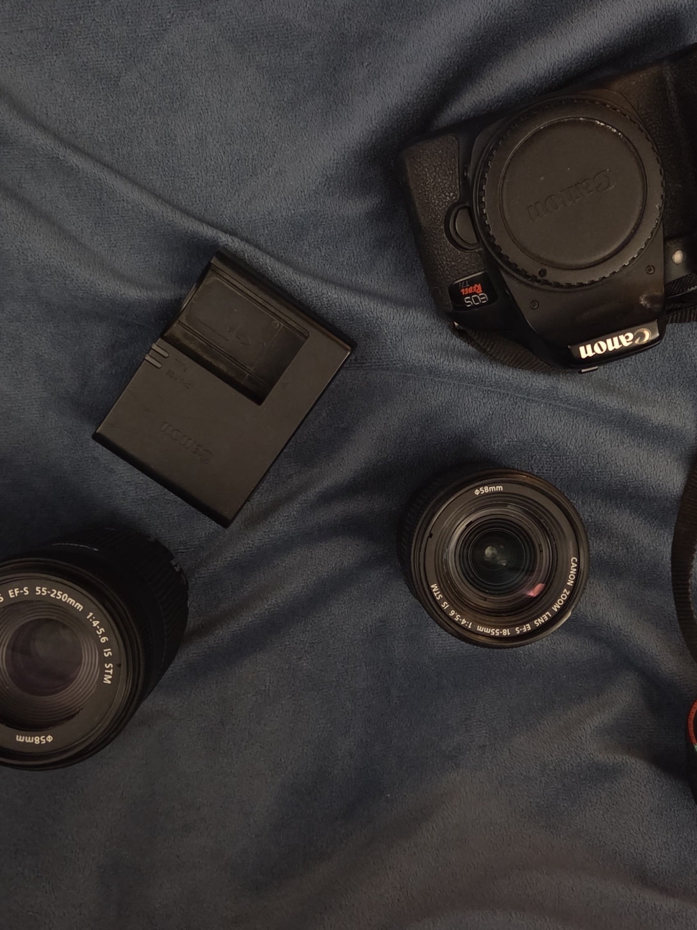 Canon black DSLR kit with two black lenses and charger